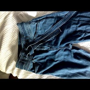 Denim flare jeans with buttons and tie belt.